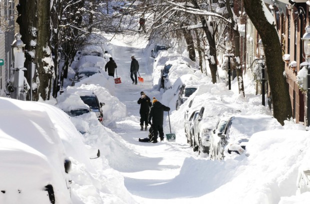 People dig out their cars after a snowstorm in Boston in February 2013. (AP/File)