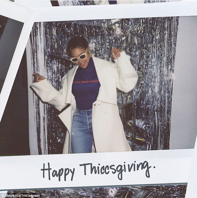 Greetings: Beyonce wished fans a happy Thanksgiving by sharing a pic showing herself dancing around wearing one of her 'Have A THICC Holiday' purple crewneck sweaters